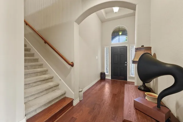 a view of a livingroom with wooden floor and furniture