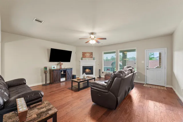 a living room with furniture fireplace and flat screen tv