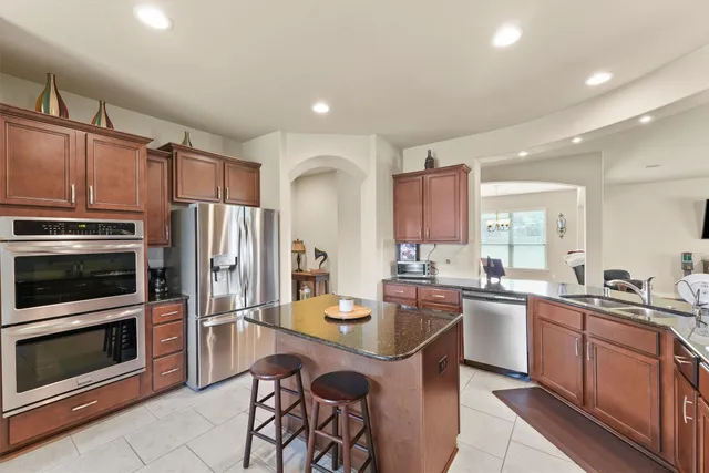 a kitchen with a sink stainless steel appliances and cabinets
