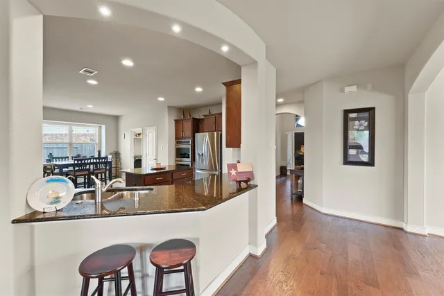 a living room with furniture a couch and a large mirror