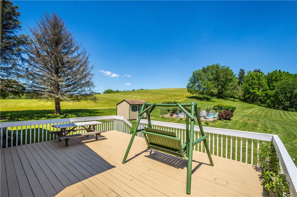 Side Deck off of the french doors coming from the living room w/steps to go out to the pool