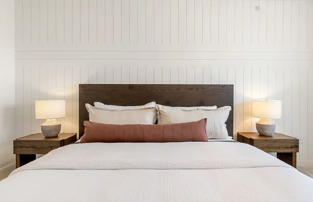 a bedroom with a bed and lamp