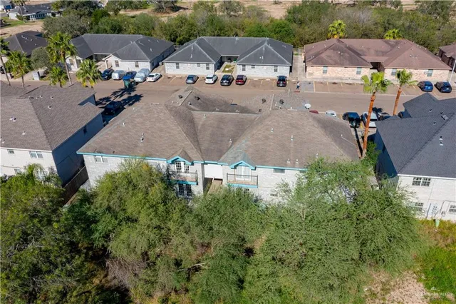 an aerial view of multiple houses with yard