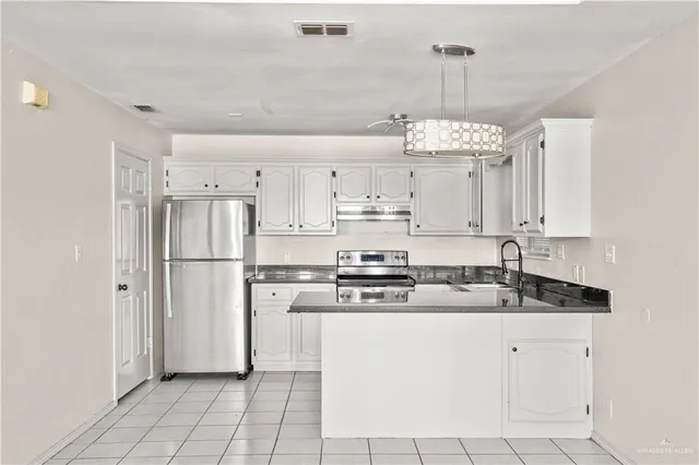 a kitchen with kitchen island granite countertop cabinets and stainless steel appliances