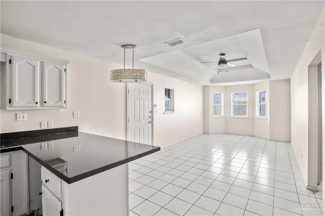 a kitchen with granite countertop a sink cabinets and window