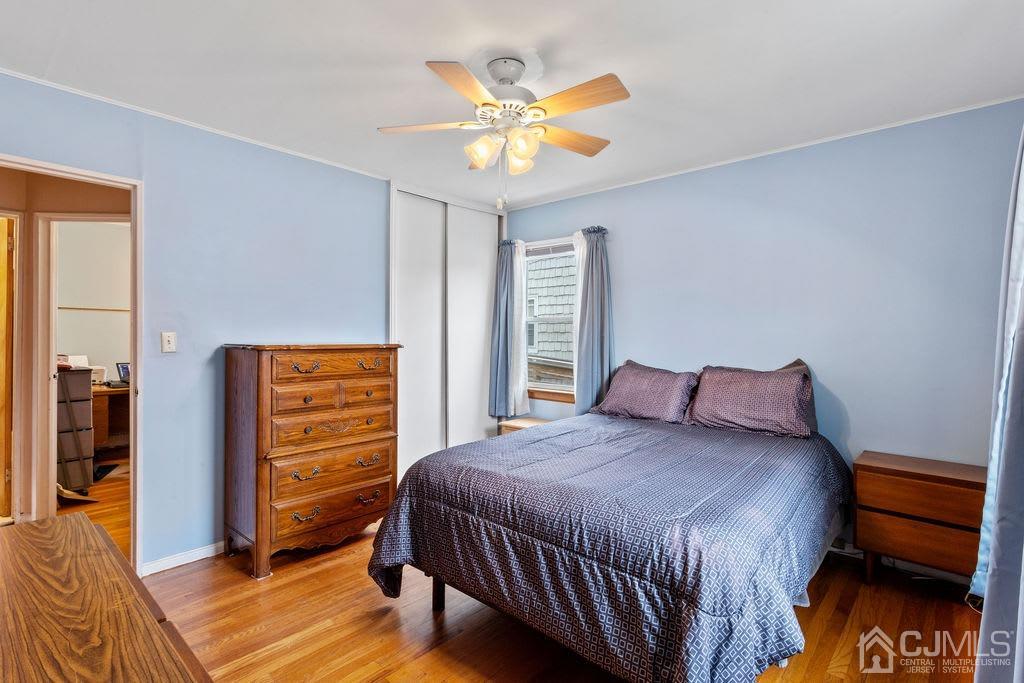 155 East Hill Road Colonia, NJ 07067 - Photo 16 of 37 a bedroom with a bed and a chandelier