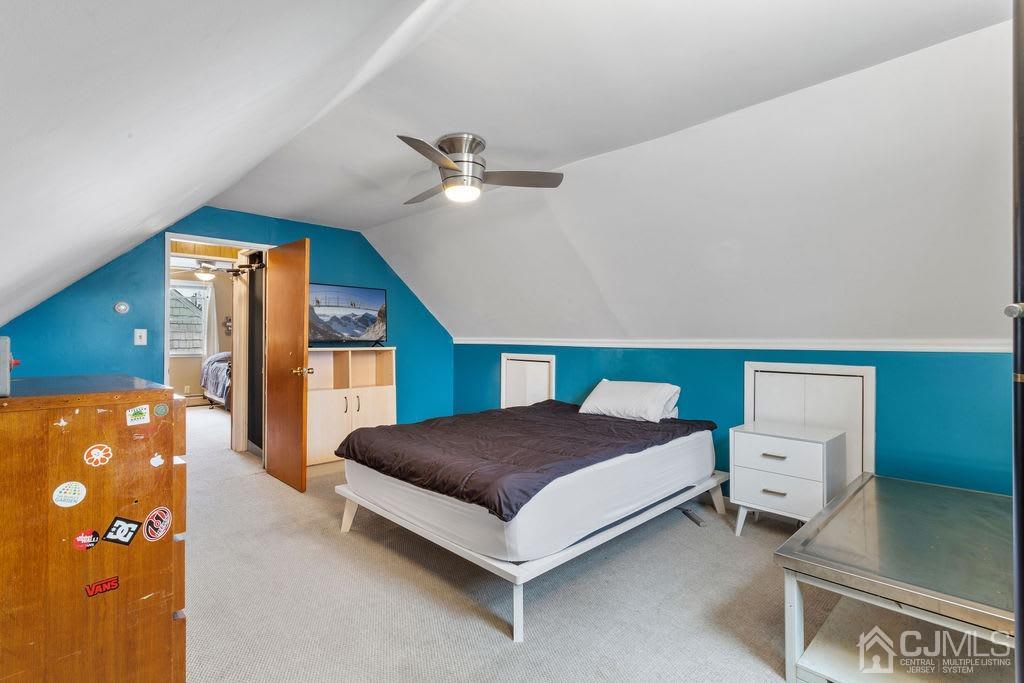 155 East Hill Road Colonia, NJ 07067 - Photo 19 of 37 a spacious bedroom with a bed and a chandelier