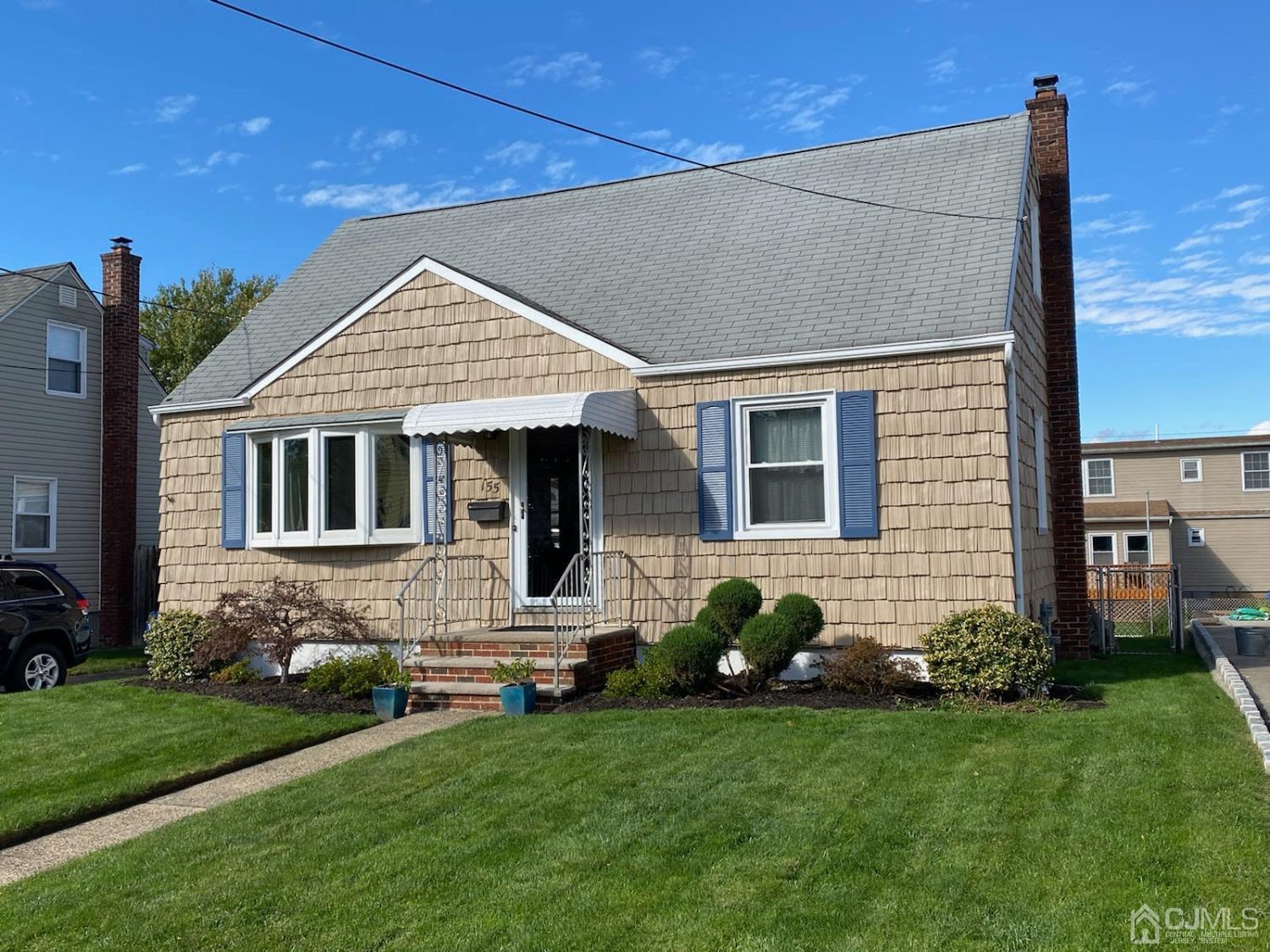 155 East Hill Road Colonia, NJ 07067 - Photo 2 of 37 a front view of a house with a garden