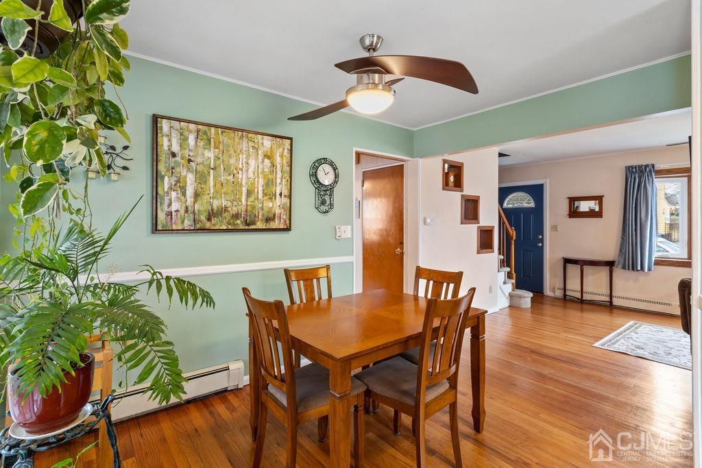 155 East Hill Road Colonia, NJ 07067 - Photo 9 of 37 a view of a dining room with furniture and wooden floor