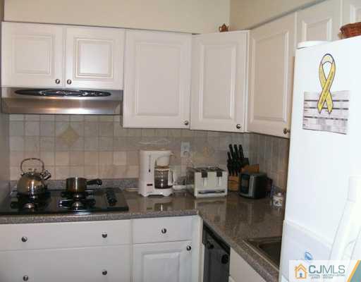 47 Haven Road Old Bridge, NJ 08857 - Photo 3 of 8 a kitchen with stainless steel appliances granite countertop a sink a stove and white cabinets
