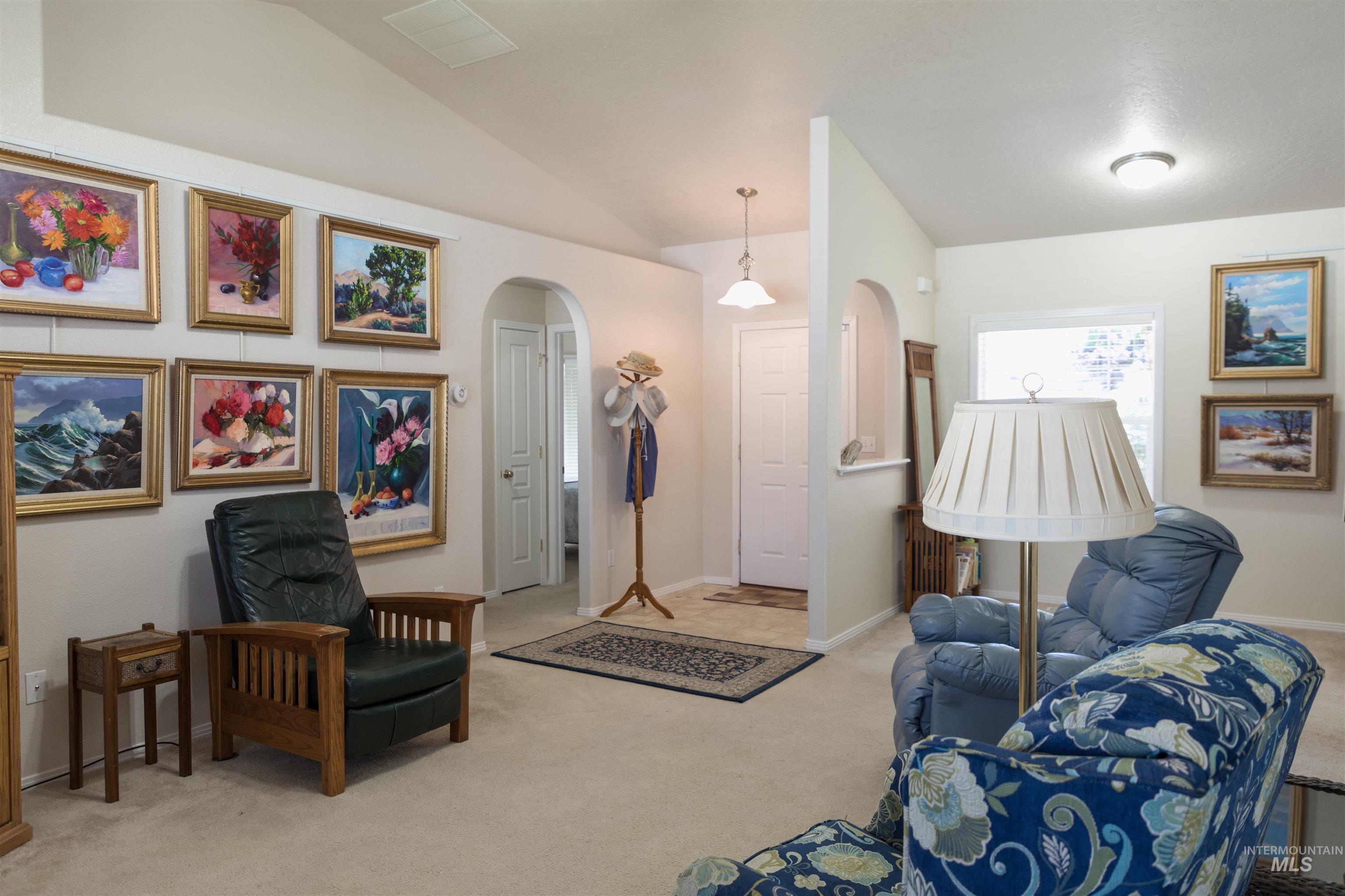 1003 Partridge Street Fruitland, ID 83619 - Photo 16 of 48 Living room with arched walkways, carpet, and vaulted ceiling
