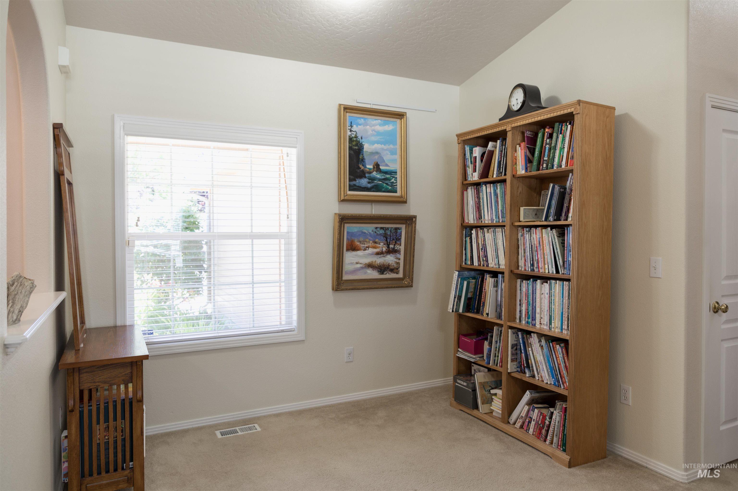 1003 Partridge Street Fruitland, ID 83619 - Photo 19 of 48 Living area with light carpet and a textured ceiling