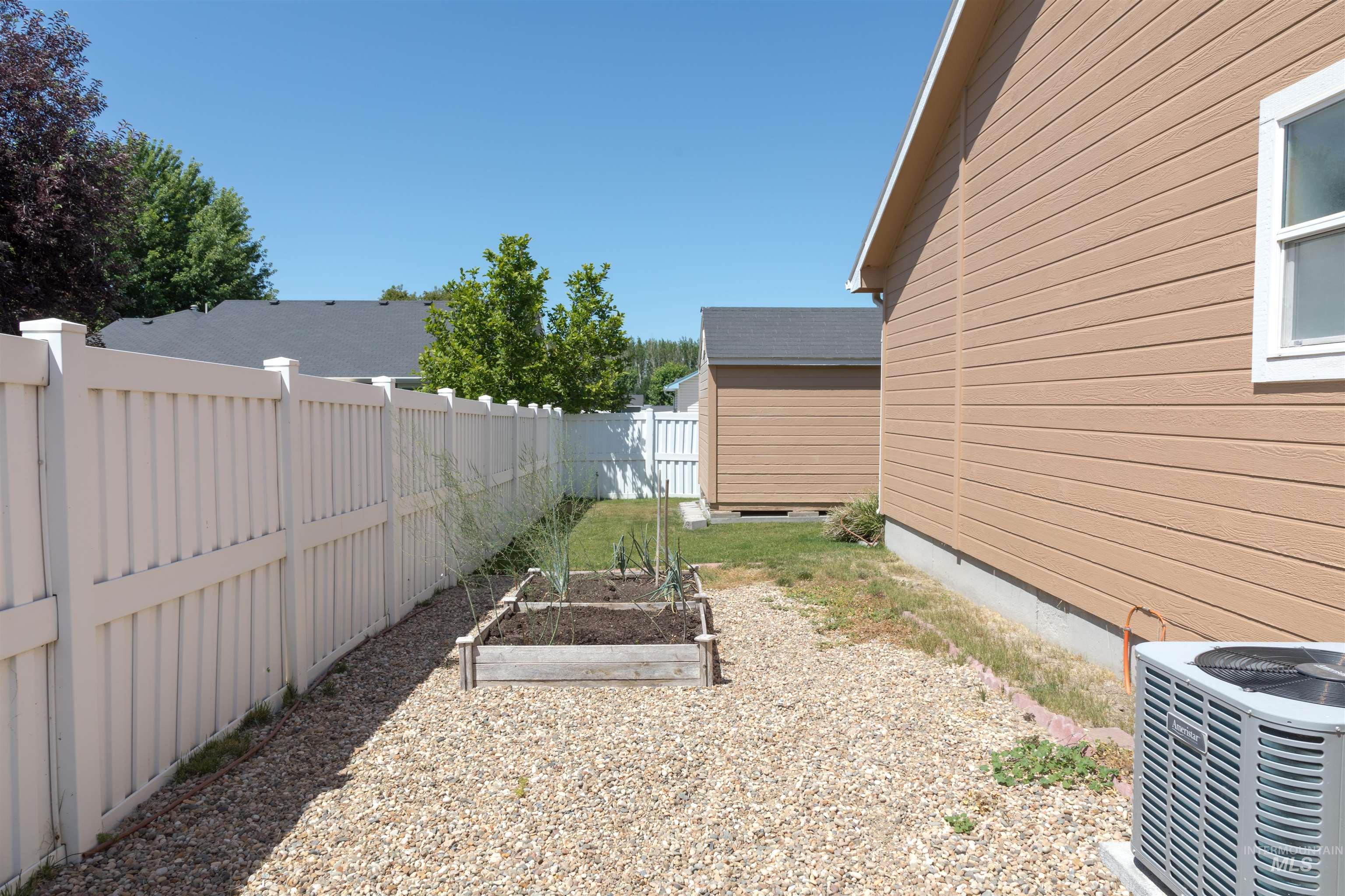 1003 Partridge Street Fruitland, ID 83619 - Photo 45 of 48 Fenced backyard with a vegetable garden