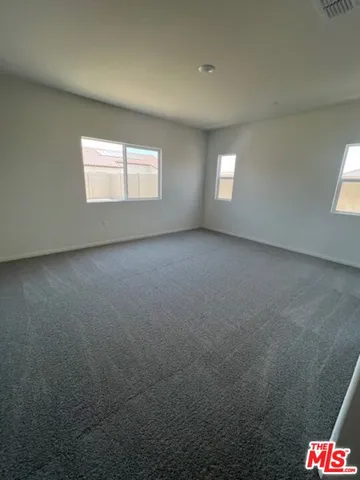 a view of an empty room and a window