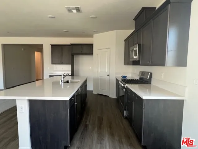 a kitchen with a sink stove and cabinets