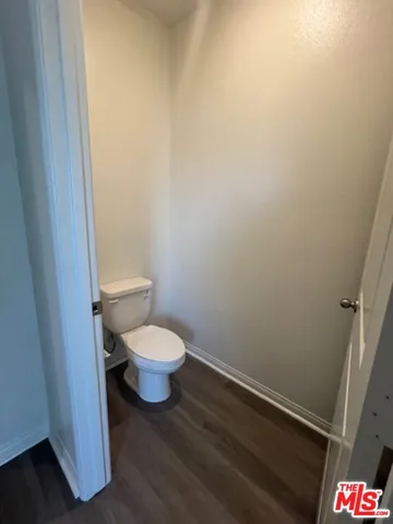 a white toilet sitting next to a white wall