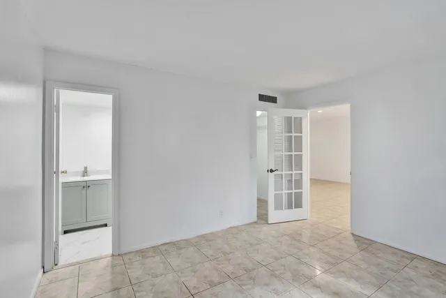 an empty room with a empty space and windows