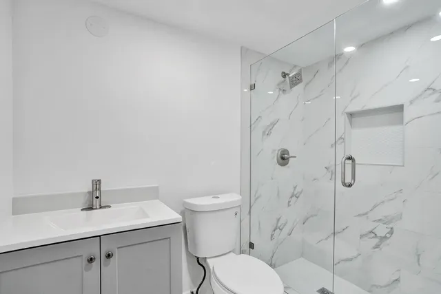 a bathroom with a toilet sink and shower