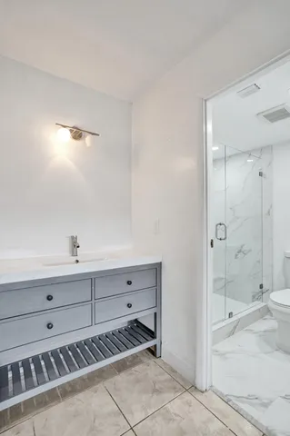 a bathroom with a shower a toilet and a shower