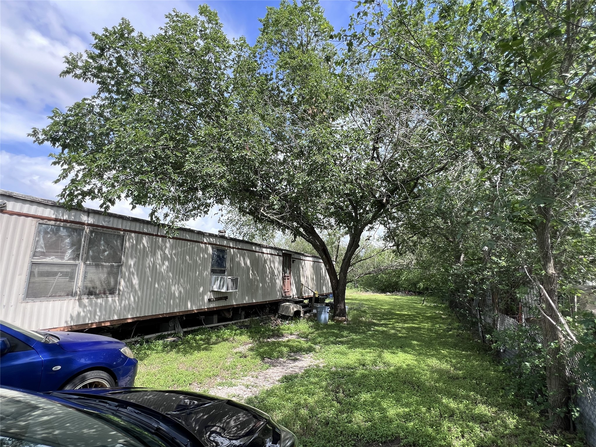 10001 Peterson Road Del Valle, TX 78617 - Photo 20 of 29 a view of backyard with large trees