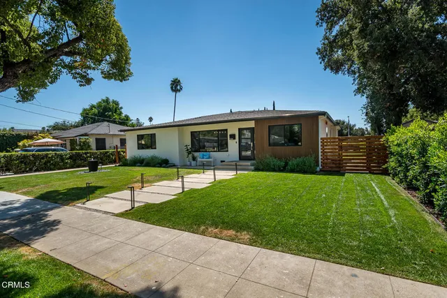 a view of house with a yard