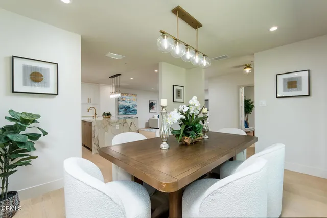 a dining room with furniture and wooden floor