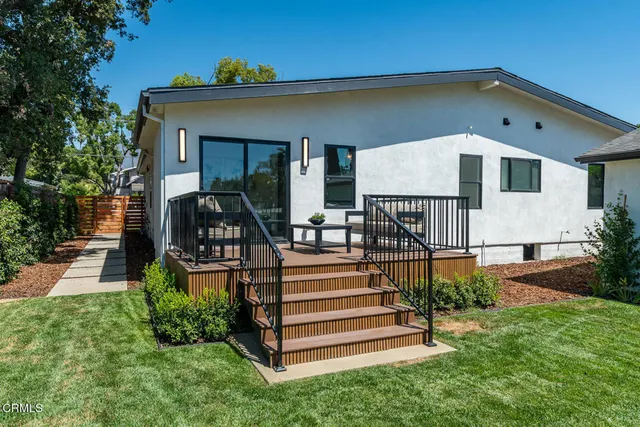 a front view of a house with yard patio and green space