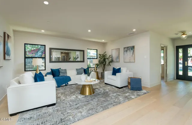 a living room with fireplace furniture and a wooden floor