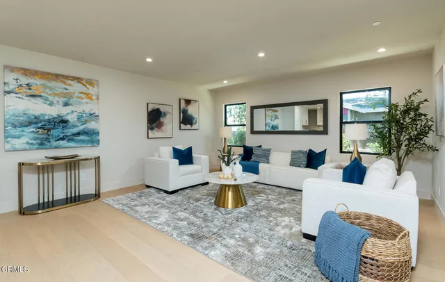a living room with furniture a window and a flat screen tv