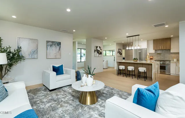 a living room with furniture and kitchen view