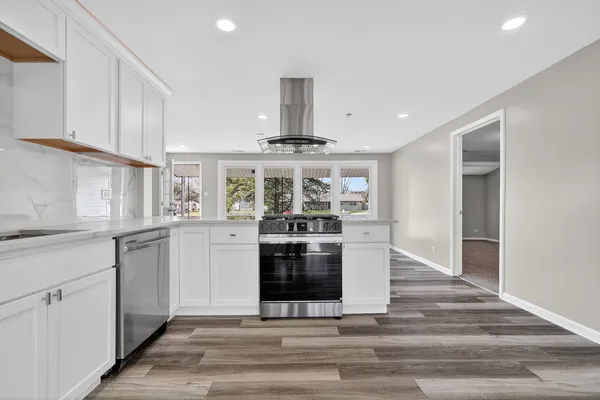 a kitchen with stainless steel appliances granite countertop a stove and a refrigerator