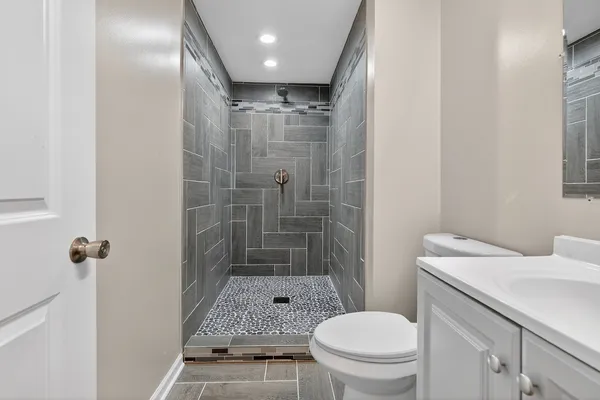 a bathroom with a sink toilet and shower