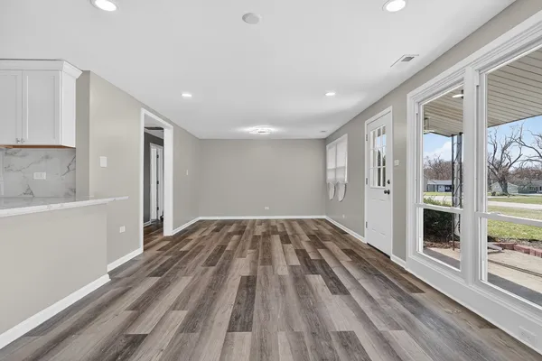 a view of a room with wooden floor
