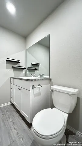 a white toilet sitting next to a bathroom sink