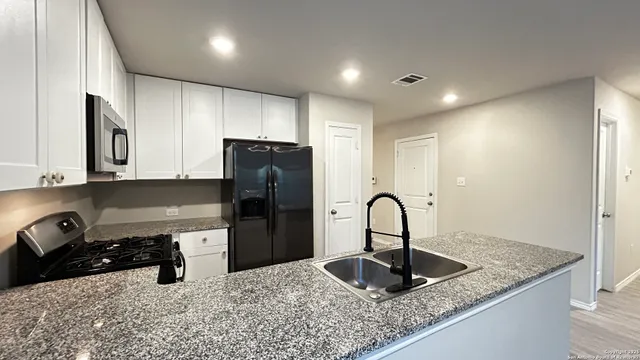 a kitchen with a sink and a refrigerator