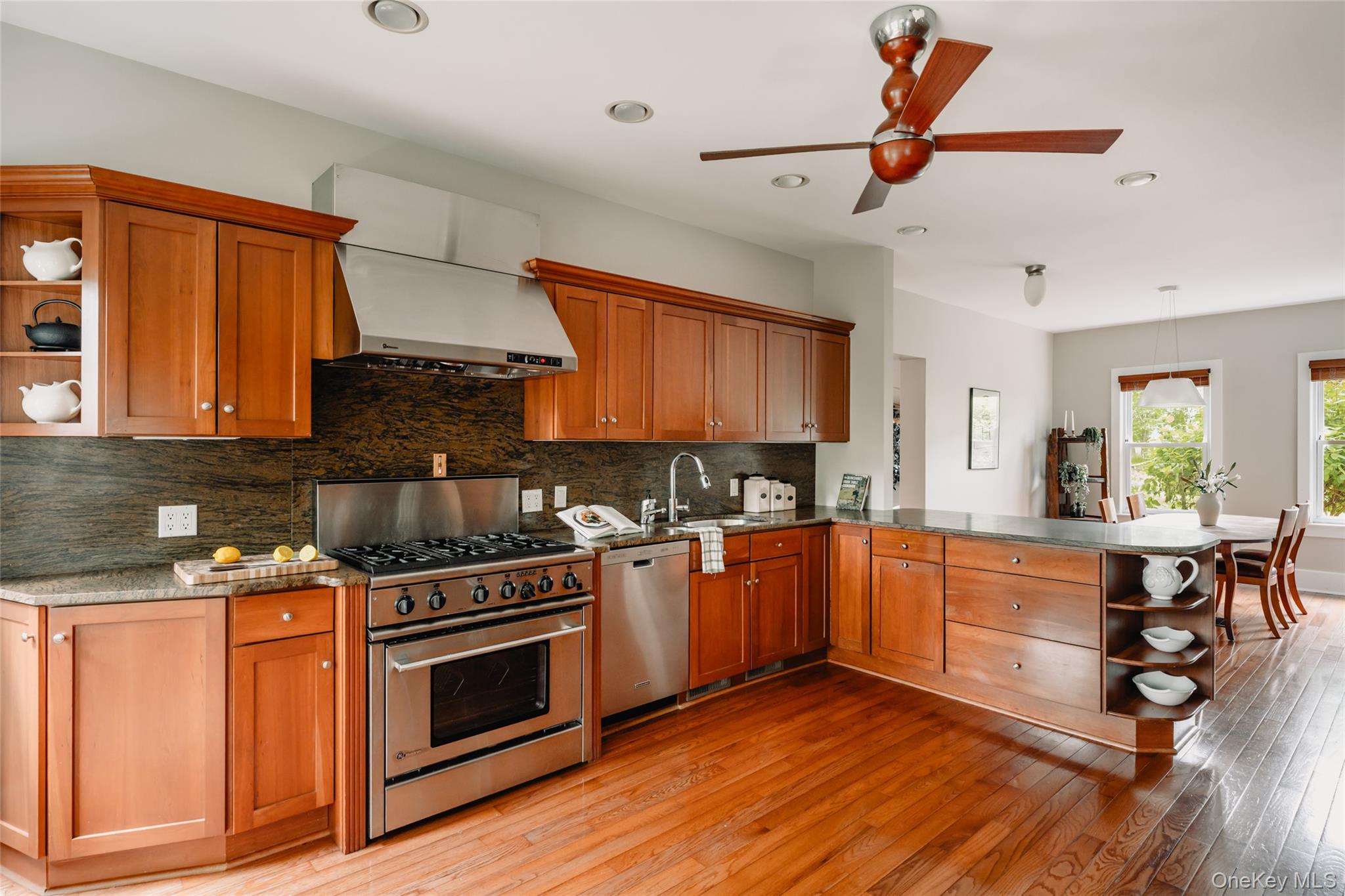 111 Jim Stephenson Road Jeffersonville, NY 12748 - Photo 11 of 50 a kitchen with stainless steel appliances granite countertop wooden floors and white cabinets