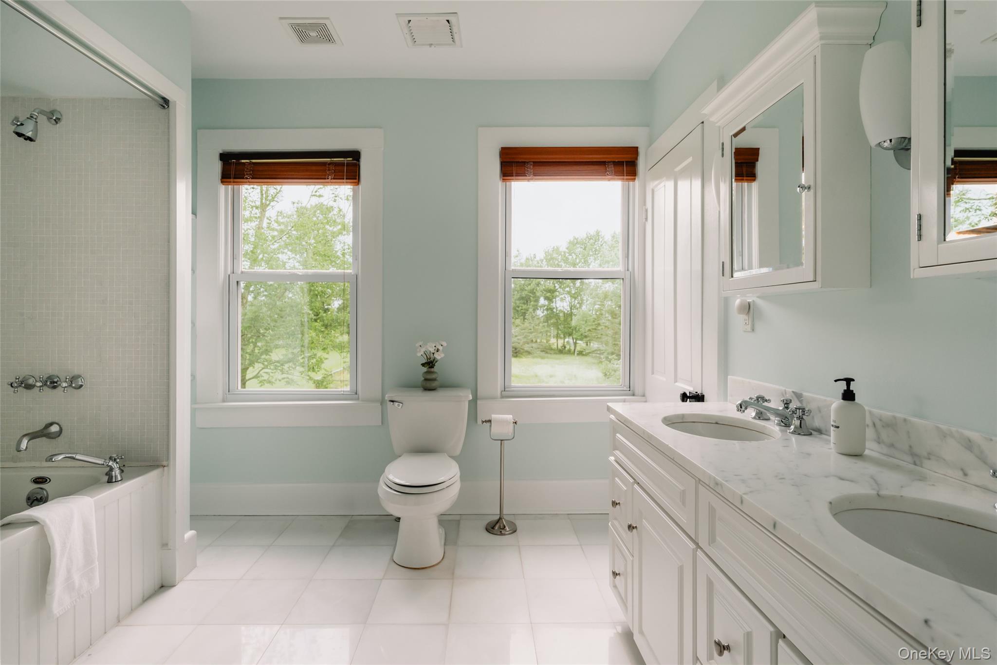 111 Jim Stephenson Road Jeffersonville, NY 12748 - Photo 24 of 50 a bathroom with a granite countertop sink toilet a large mirror and a window