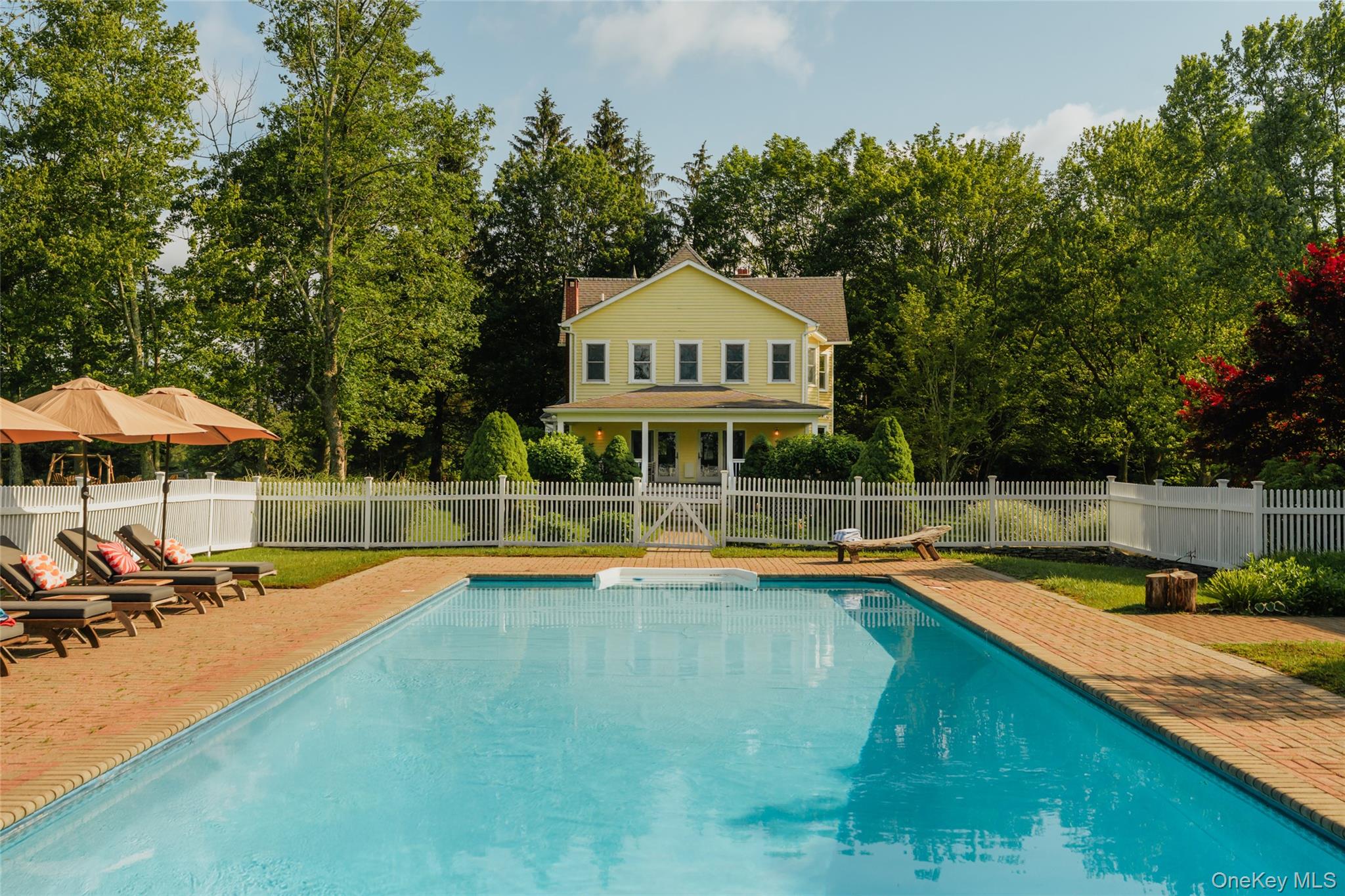 111 Jim Stephenson Road Jeffersonville, NY 12748 - Photo 30 of 50 a view of a swimming pool with lawn chairs under an umbrella