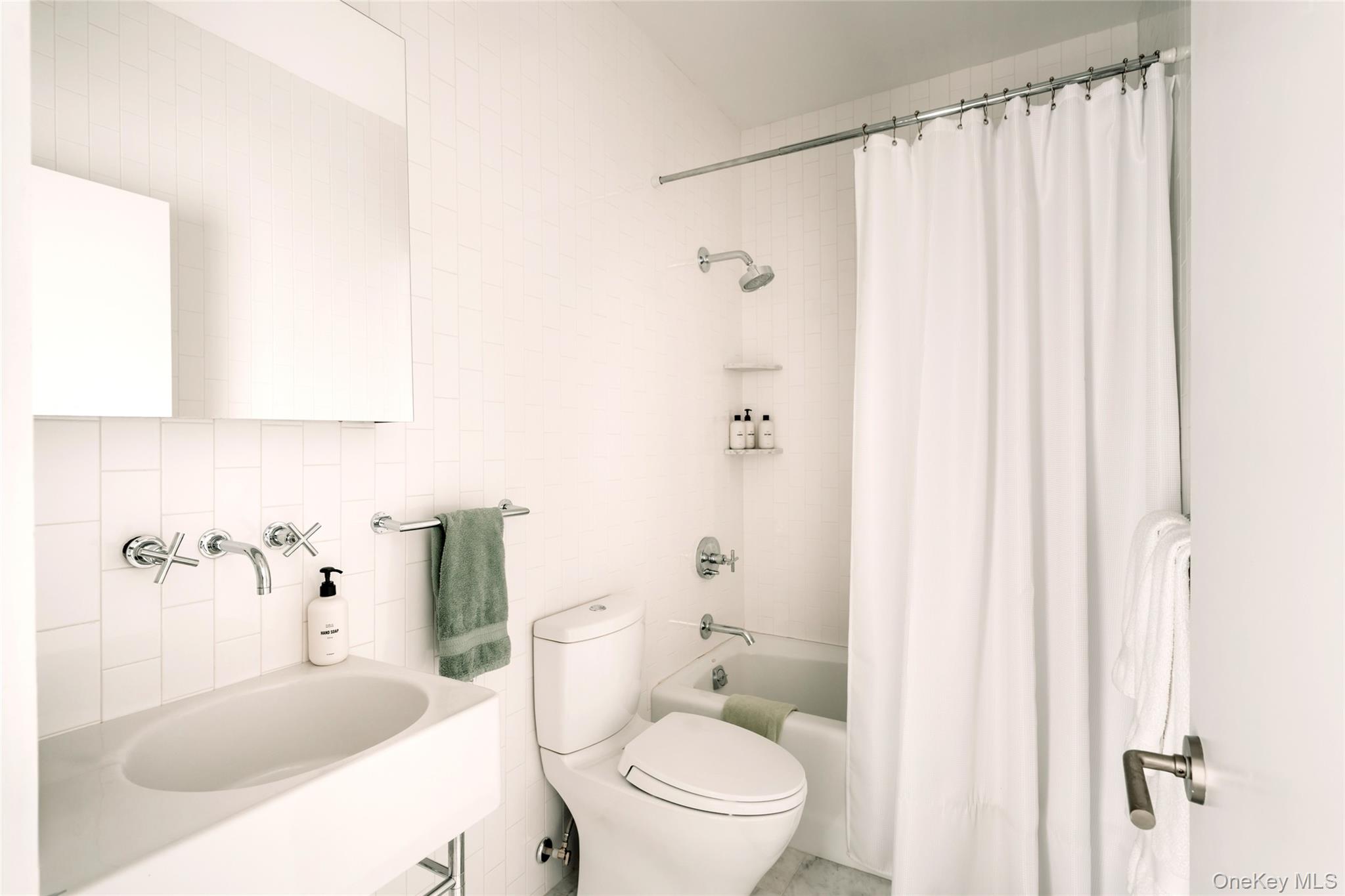 111 Jim Stephenson Road Jeffersonville, NY 12748 - Photo 41 of 50 a white toilet sitting next to a bathroom sink