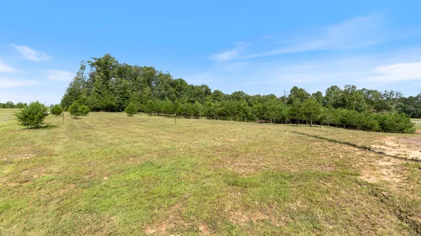 a view of a field with an outdoor space