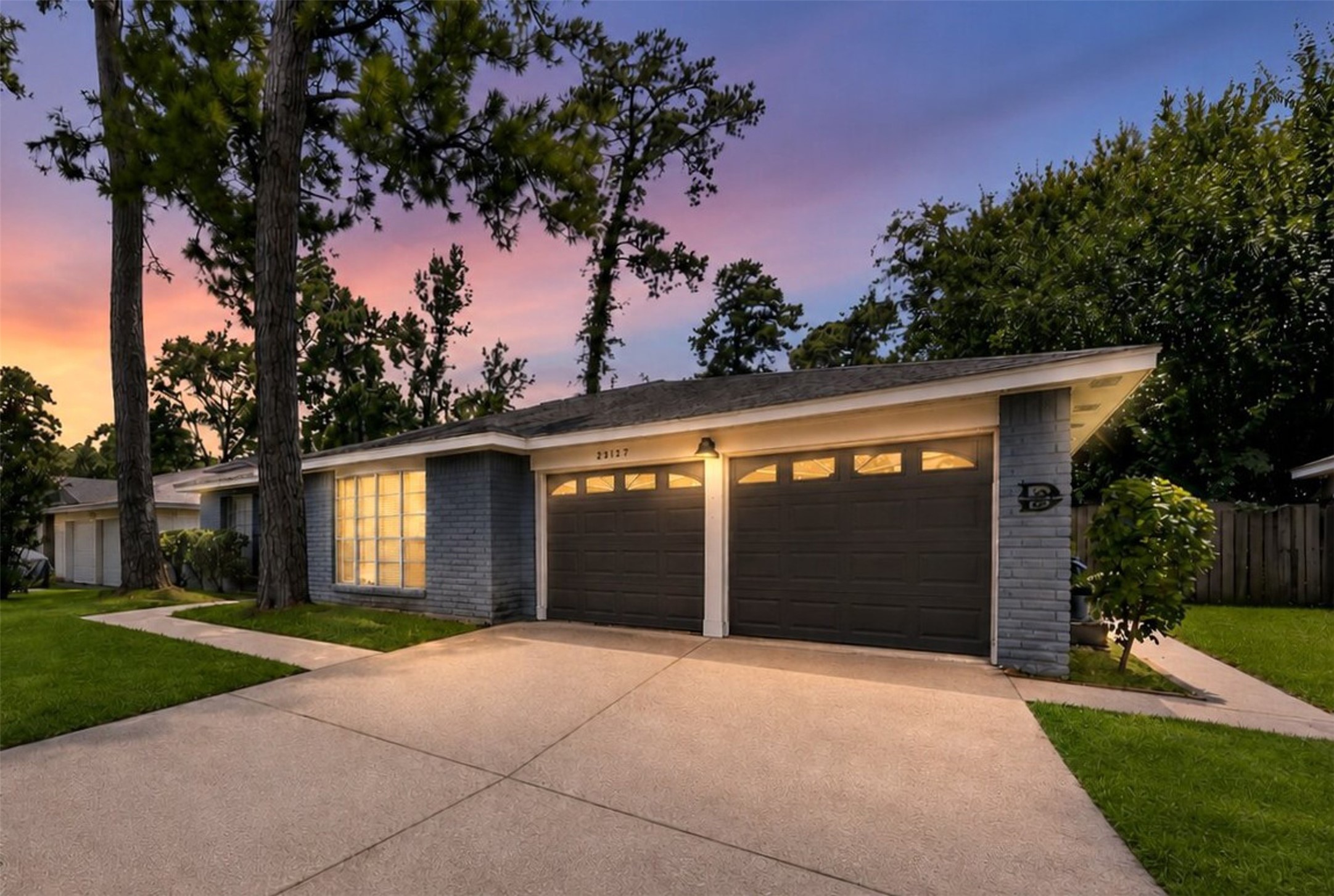 23127 Harpergate Drive Spring, TX 77373 - Photo 1 of 26 Twilight exterior showcases the home's inviting curb appeal.