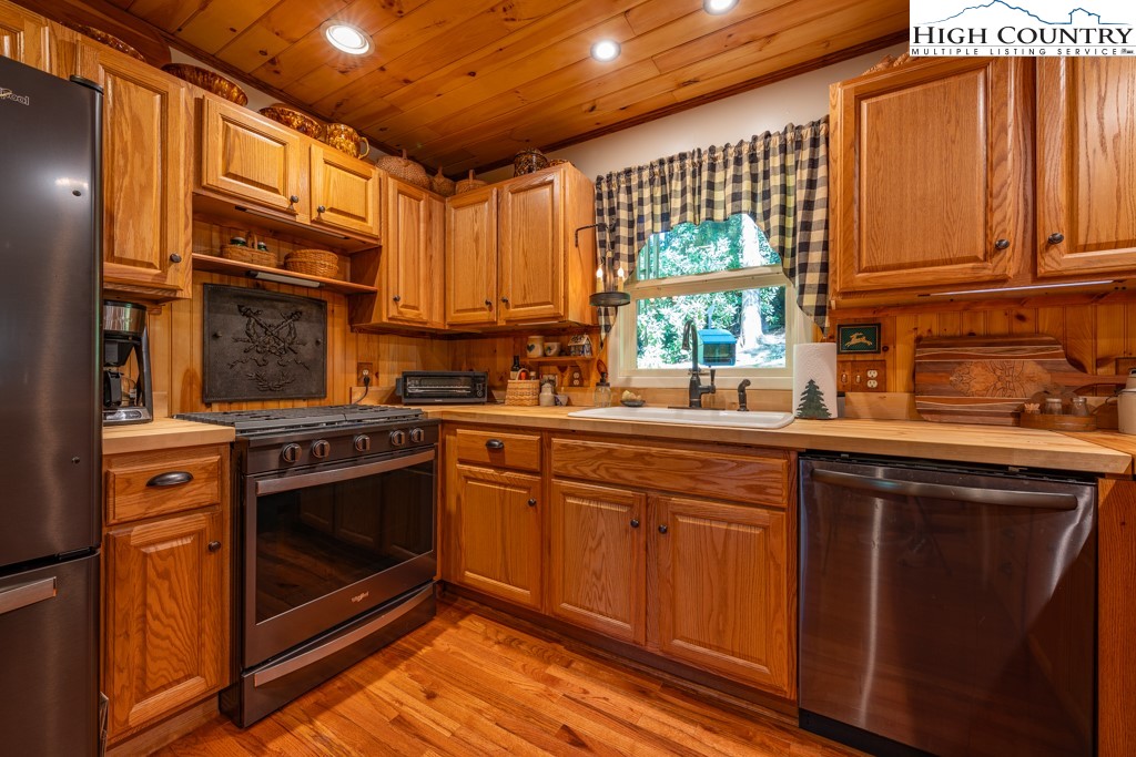 307 Lakeview Road Newland, NC 28657 - Photo 17 of 49 a kitchen with stainless steel appliances granite countertop a stove a sink and a microwave