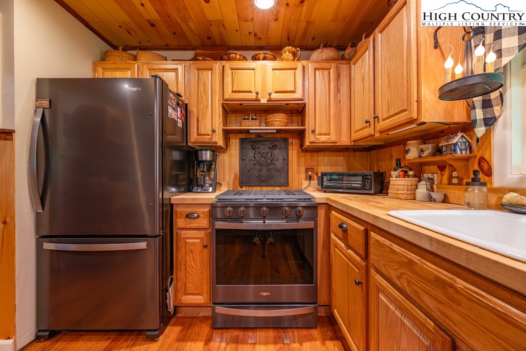 307 Lakeview Road Newland, NC 28657 - Photo 18 of 49 a kitchen with stainless steel appliances granite countertop a refrigerator and a stove