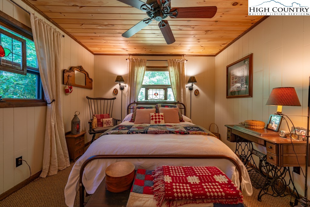 307 Lakeview Road Newland, NC 28657 - Photo 29 of 49 a bedroom with a bed and a chandelier