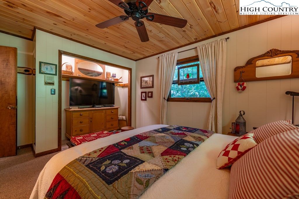 307 Lakeview Road Newland, NC 28657 - Photo 30 of 49 a bedroom with a large bed and a flat tv screen