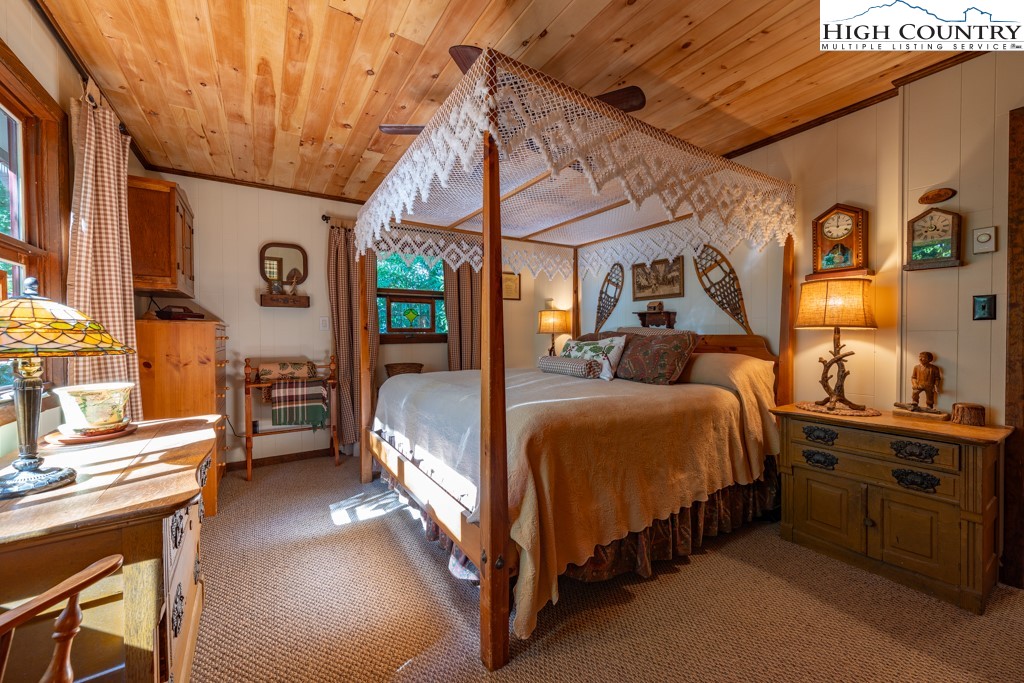 307 Lakeview Road Newland, NC 28657 - Photo 31 of 49 a bedroom with a bed and a chandelier