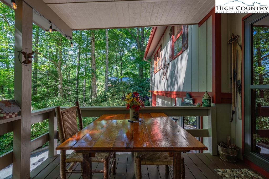 307 Lakeview Road Newland, NC 28657 - Photo 9 of 49 a view of a patio with table and chairs and potted plants with wooden floor
