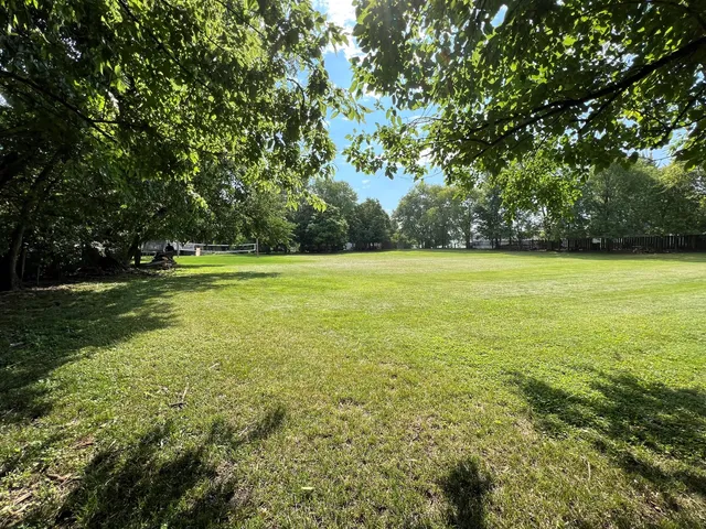 a view of a field with an outdoor space