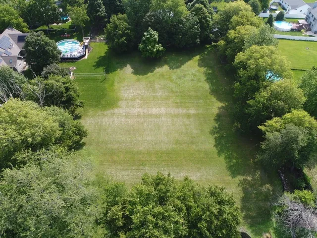 an aerial view of a residential houses with yard