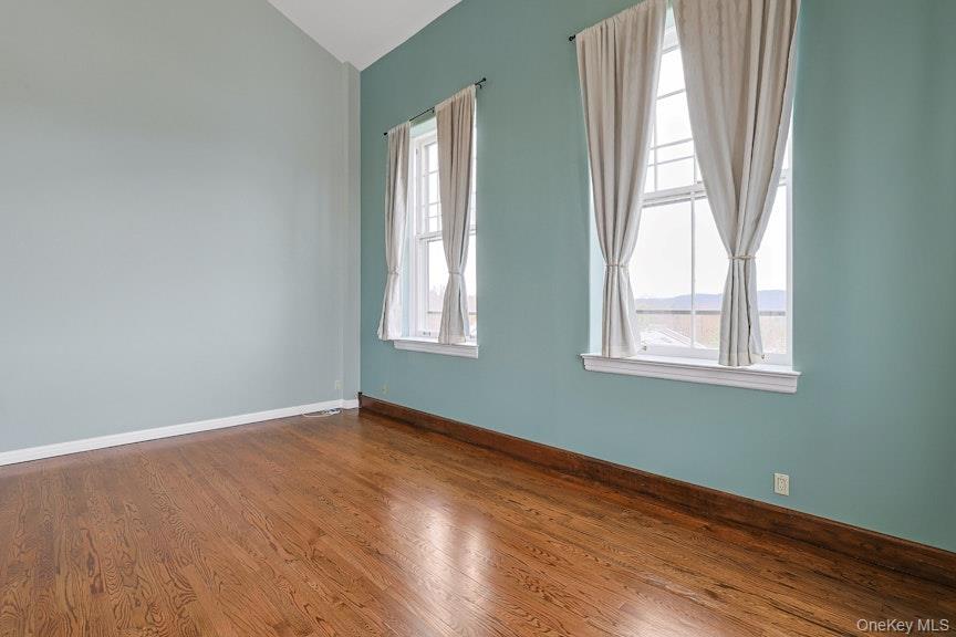 1701 Crompond Road, Unit 6304 Peekskill, NY 10566 - Photo 17 of 23 an empty room with wooden floor and windows